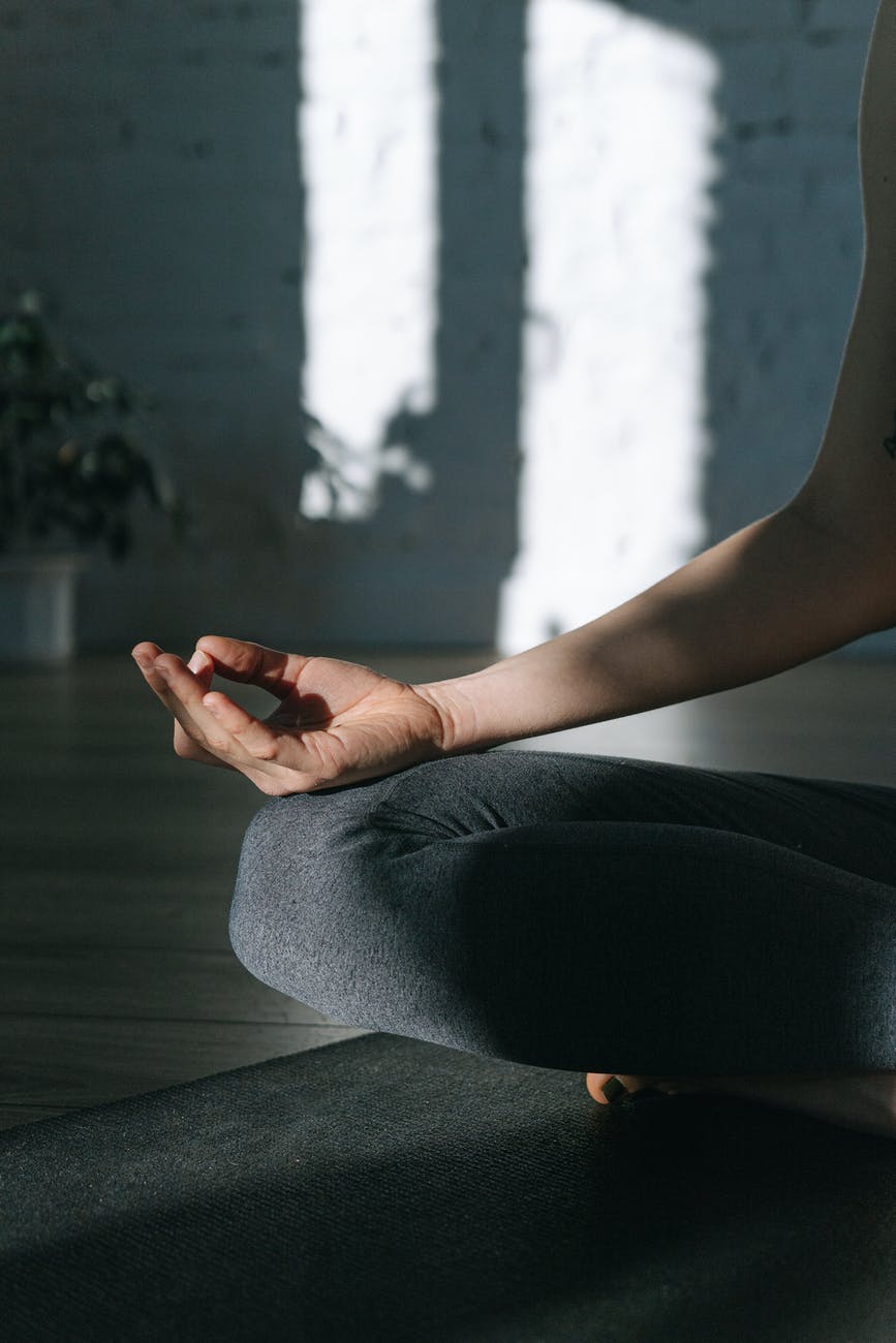 a person sitting on the floor while doing yoga